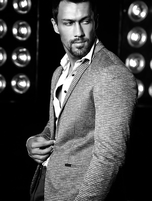 Portrait of sexy handsome fashion male model man dressed in elegant suit on black studio lights background123420636_XS Portrait of sexy handsome fashion male model man dressed in elegant suit on black studio lights background123420636_XS