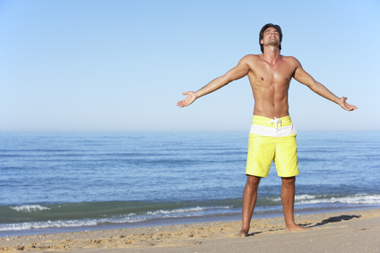 Young Man Standing On Summer Beach_84419817_XS